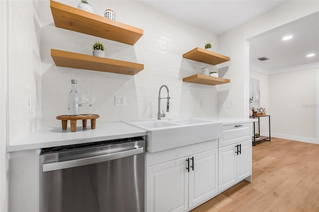 526 62nd Ave NE, Saint Petersburg, FL 33702 - kitchen featuring stainless steel dishwasher, open shelves, a sink, tasteful backsplash, and light wood-style flooring
