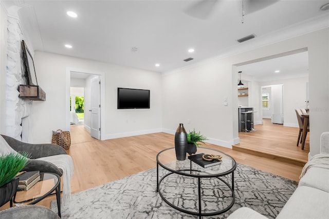 526 62nd Ave NE, Saint Petersburg, FL 33702 - living room with light wood-style floors, plenty of natural light, recessed lighting, crown molding, and baseboards