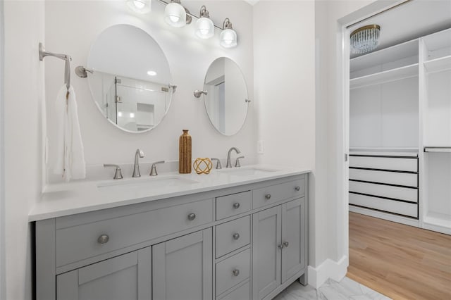526 62nd Ave NE, Saint Petersburg, FL 33702 - bathroom with double vanity, baseboards, marble finish flooring, and a shower