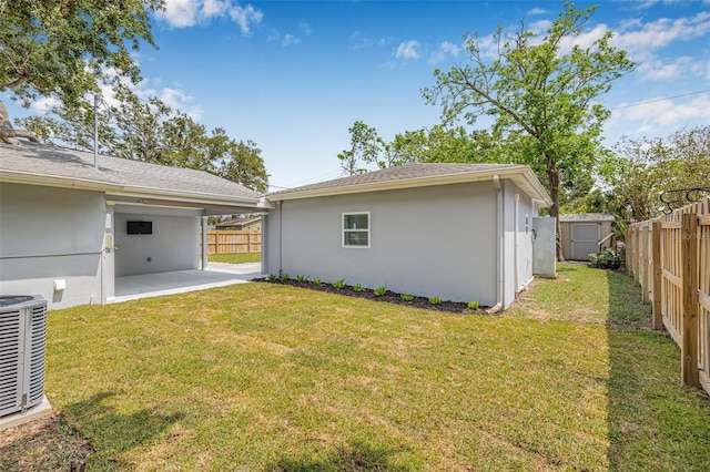 526 62nd Ave NE, Saint Petersburg, FL 33702 - back of house featuring a patio, central AC, stucco siding, a storage shed, and an outbuilding