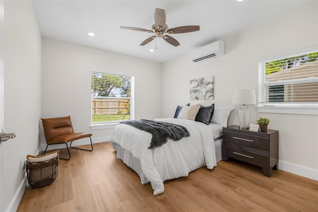 526 62nd Ave NE, Saint Petersburg, FL 33702 - bedroom with a wall mounted AC, multiple windows, baseboards, light wood finished floors, and recessed lighting