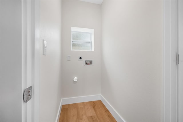526 62nd Ave NE, Saint Petersburg, FL 33702 - clothes washing area featuring electric dryer hookup, washer hookup, baseboards, and light wood-type flooring