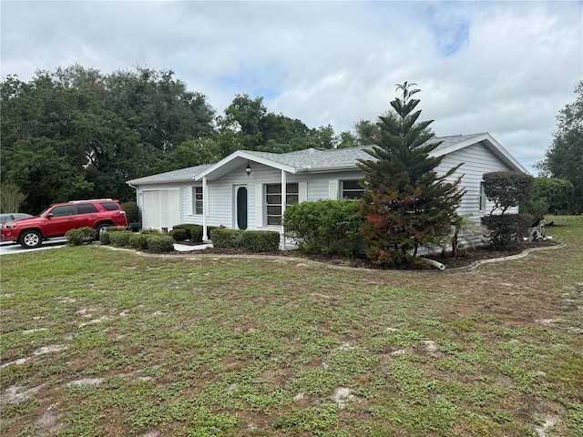 ranch-style home with a front lawn