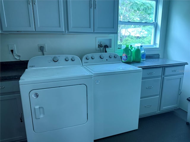 laundry room featuring independent washer and dryer and cabinet space