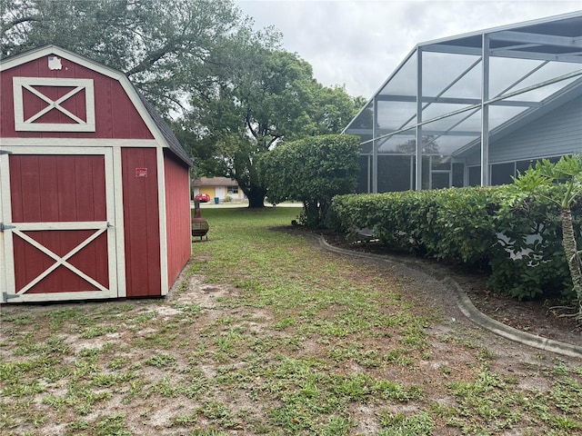 view of green lawn featuring a storage shed and an outdoor structure