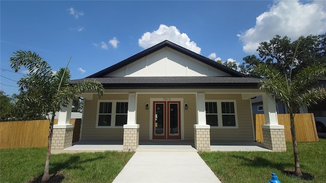7013 N 15th St, Tampa, FL 33610 - view of front facade with covered porch, french doors, and roof with shingles