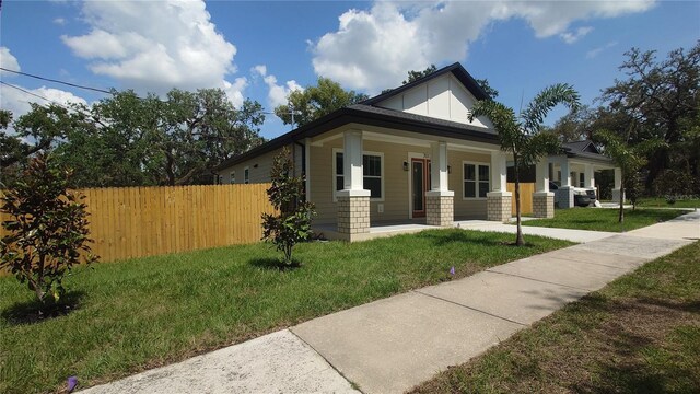 7013 N 15th St, Tampa, FL 33610 - view of front facade featuring covered porch