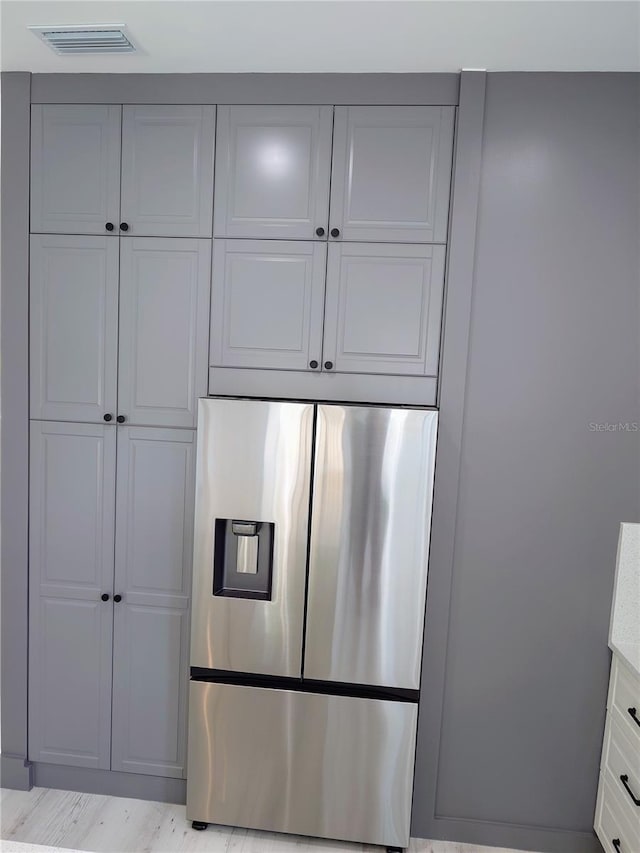 7013 N 15th St, Tampa, FL 33610 - kitchen with stainless steel fridge and white cabinetry