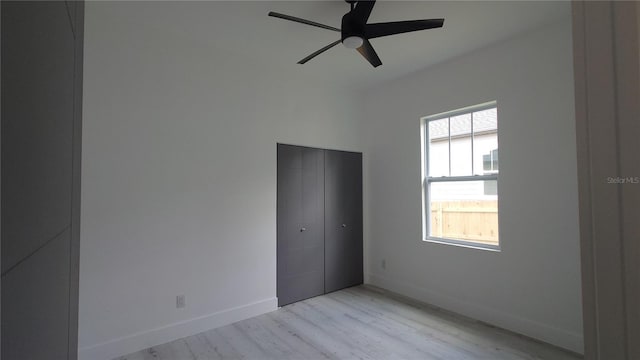 7013 N 15th St, Tampa, FL 33610 - unfurnished bedroom featuring light wood-style floors, baseboards, a closet, and ceiling fan