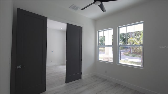 7013 N 15th St, Tampa, FL 33610 - unfurnished bedroom featuring light wood-style flooring, baseboards, and ceiling fan