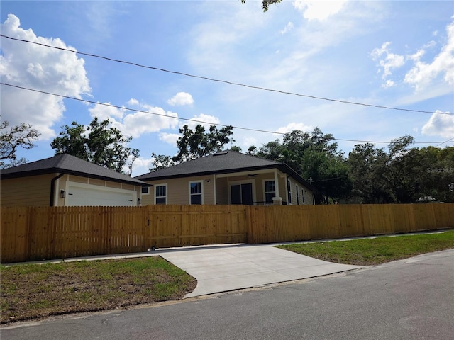 7013 N 15th St, Tampa, FL 33610 - view of front of house with a fenced front yard, a gate, and a garage