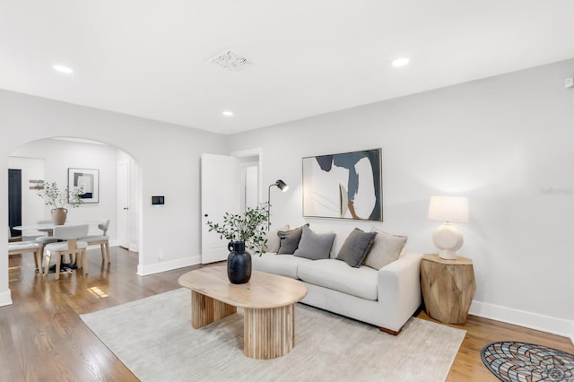 2859 Dartmouth Ave N, Saint Petersburg, FL 33713 - living area with arched walkways, baseboards, light wood-type flooring, and recessed lighting