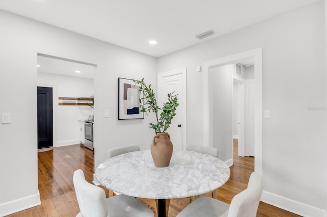 2859 Dartmouth Ave N, Saint Petersburg, FL 33713 - dining area with baseboards, wood finished floors, and recessed lighting