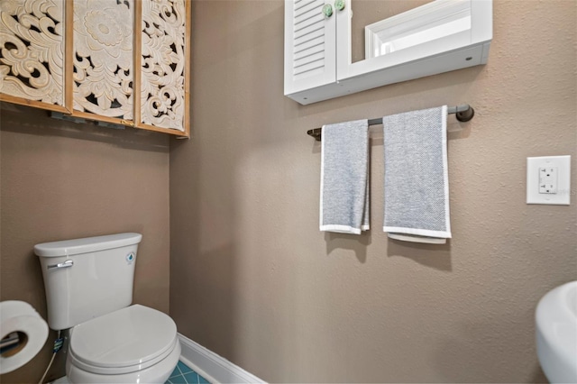 2859 Dartmouth Ave N, Saint Petersburg, FL 33713 - bathroom with toilet, baseboards, and tile patterned flooring