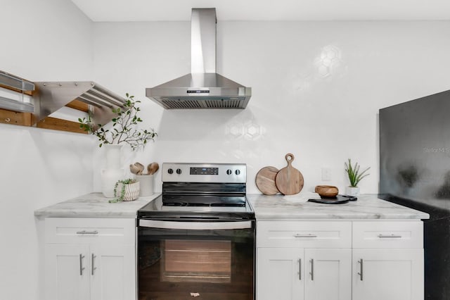 2859 Dartmouth Ave N, Saint Petersburg, FL 33713 - kitchen with electric range, wall chimney range hood, white cabinetry, freestanding refrigerator, and light stone counters