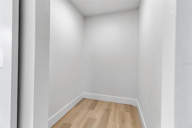 unfurnished room with light wood finished floors and baseboards