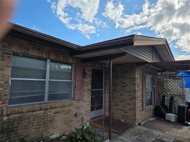 115 Marjorie Ave, Auburndale, FL 33823 - view of home's exterior featuring brick siding and a patio area