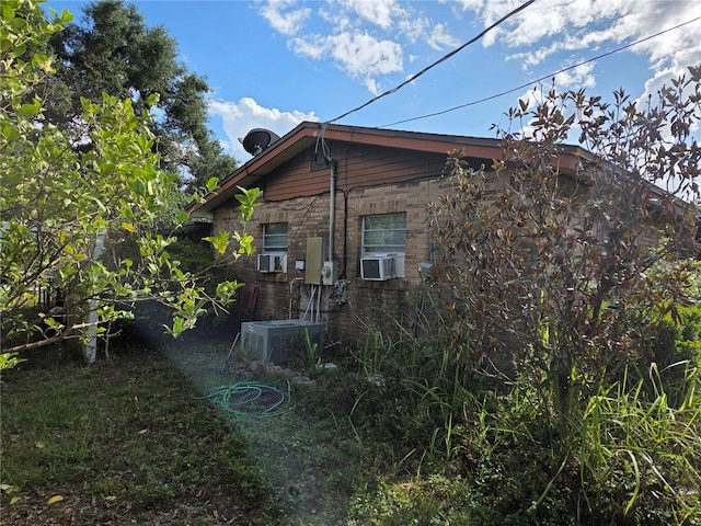115 Marjorie Ave, Auburndale, FL 33823 - view of side of home featuring central AC and cooling unit