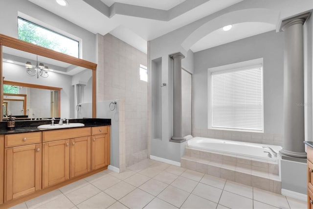 bathroom featuring ornate columns, a bath, a walk in shower, vanity, and tile patterned floors