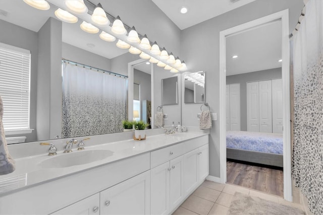 full bathroom featuring tile patterned floors, double vanity, and a shower with curtain