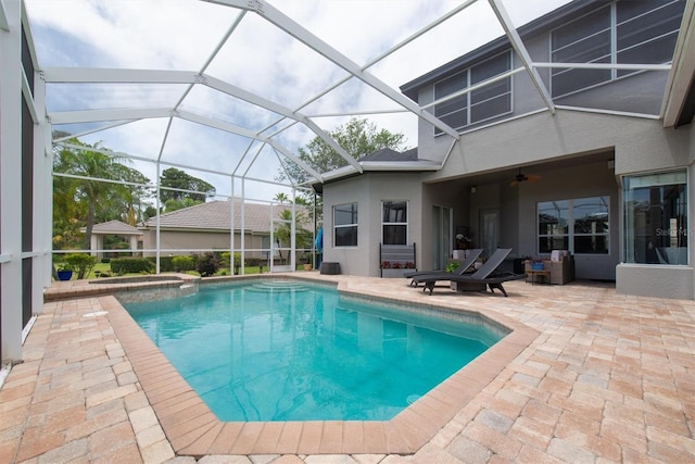 view of swimming pool with a patio area, a pool with connected hot tub, a lanai, and ceiling fan