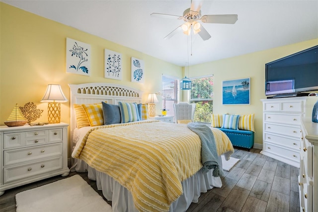 bedroom featuring wood finished floors, a ceiling fan, and baseboards