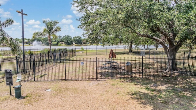 view of yard featuring a water view and fence