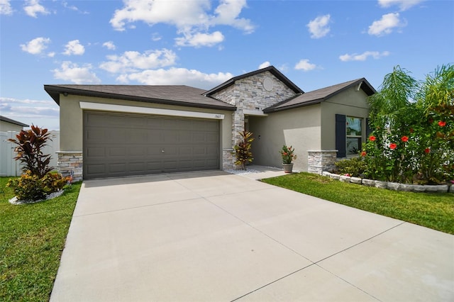 13603 Wild Ginger St, Riverview, FL 33579 - view of front of home featuring stone siding, stucco siding, an attached garage, and driveway