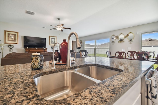 13603 Wild Ginger St, Riverview, FL 33579 - kitchen with a sink, dark stone counters, ceiling fan, and open floor plan