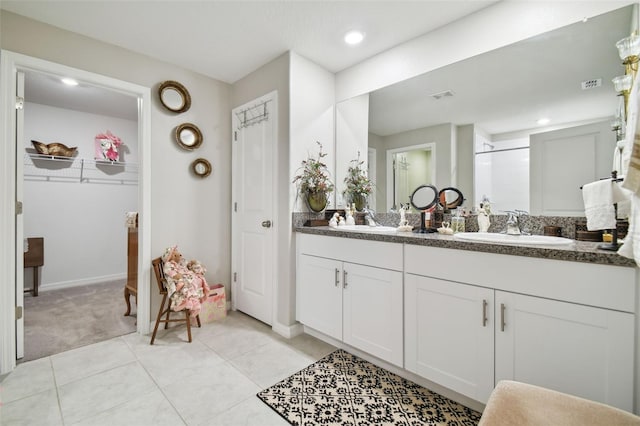 13603 Wild Ginger St, Riverview, FL 33579 - full bath with a shower stall, double vanity, tile patterned floors, a walk in closet, and baseboards