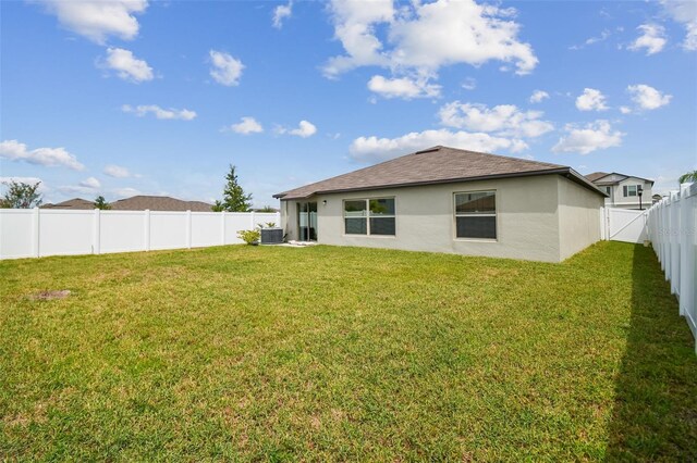 13603 Wild Ginger St, Riverview, FL 33579 - back of house with stucco siding, central air condition unit, and roof with shingles