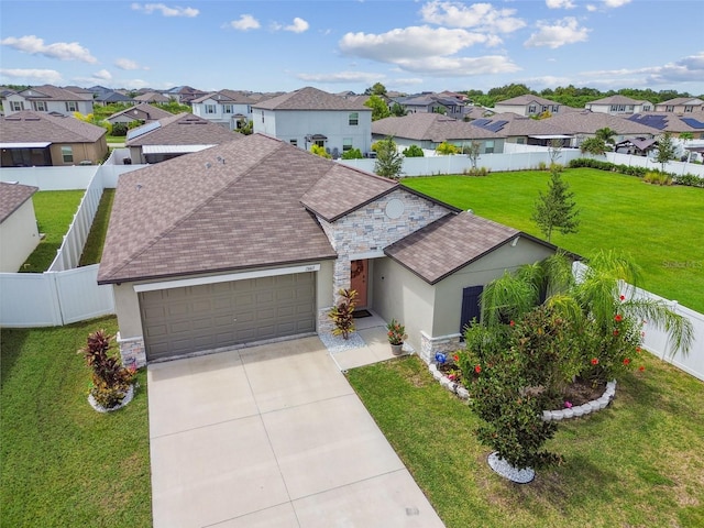 13603 Wild Ginger St, Riverview, FL 33579 - view of front facade with a garage, a residential view, stucco siding, concrete driveway, and stone siding