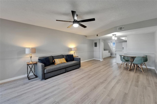 1028 Apollo Beach Blvd Unit 21, Apollo Beach, FL 33572 - living room featuring stairs, a textured ceiling, wood finished floors, baseboards, and a ceiling fan