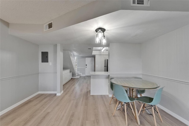 1028 Apollo Beach Blvd Unit 21, Apollo Beach, FL 33572 - dining room featuring stairway, light wood finished floors, baseboards, and a textured ceiling