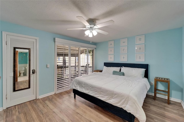 1028 Apollo Beach Blvd Unit 21, Apollo Beach, FL 33572 - bedroom with wood finished floors, baseboards, a textured ceiling, access to exterior, and a ceiling fan