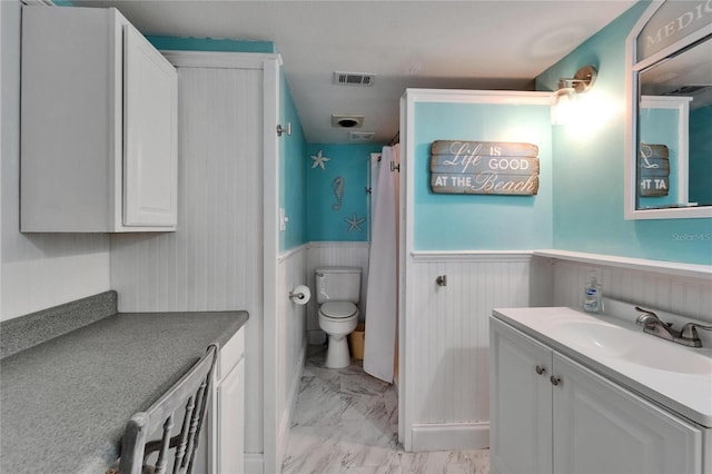 1028 Apollo Beach Blvd Unit 21, Apollo Beach, FL 33572 - bathroom with marble look tiles, toilet, wainscoting, vanity, and a shower with shower curtain