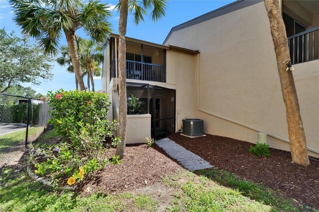 1028 Apollo Beach Blvd Unit 21, Apollo Beach, FL 33572 - rear view of property with central air condition unit, stucco siding, fence, and a balcony