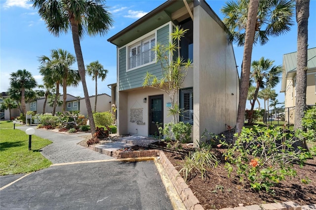 1028 Apollo Beach Blvd Unit 21, Apollo Beach, FL 33572 - view of front of house featuring stucco siding and fence