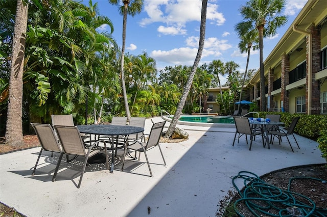 208 Danube Ave Unit 101, Tampa, FL 33606 - view of patio featuring outdoor dining space and an outdoor pool