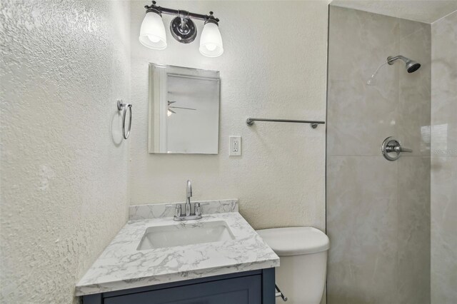 208 Danube Ave Unit 101, Tampa, FL 33606 - bathroom with a tile shower, vanity, and toilet