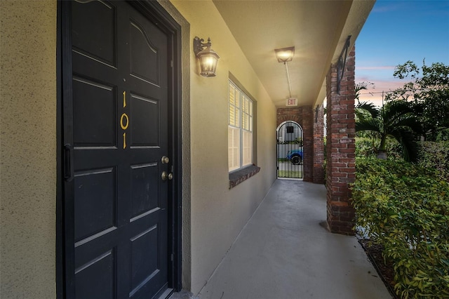 208 Danube Ave Unit 101, Tampa, FL 33606 - doorway to property with stucco siding and a gate