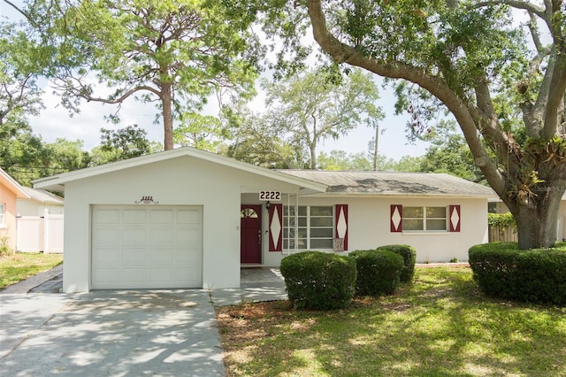 2222 Euclid Cir N, Clearwater, FL 33764 - ranch-style house featuring an attached garage, driveway, and stucco siding