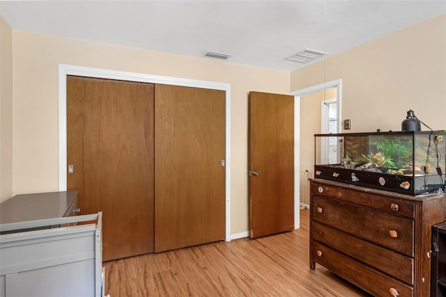 2222 Euclid Cir N, Clearwater, FL 33764 - bedroom featuring light wood-style floors, a closet, baseboards, and attic access