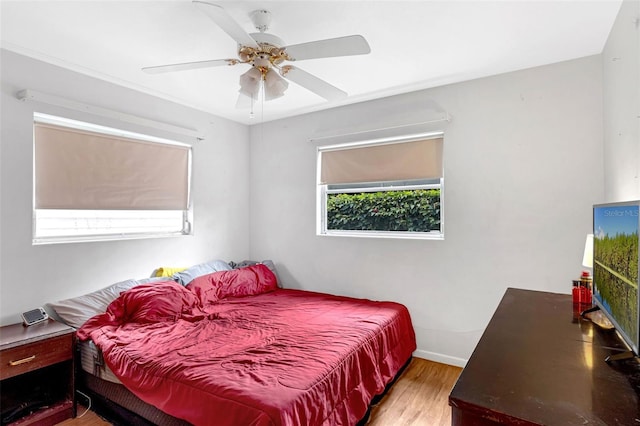2222 Euclid Cir N, Clearwater, FL 33764 - bedroom with light wood-type flooring, baseboards, and a ceiling fan