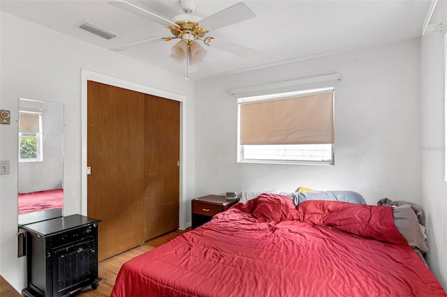 2222 Euclid Cir N, Clearwater, FL 33764 - bedroom featuring light wood finished floors, a closet, and ceiling fan