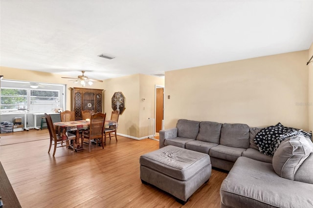 2222 Euclid Cir N, Clearwater, FL 33764 - living room with wood finished floors, ceiling fan, and baseboards