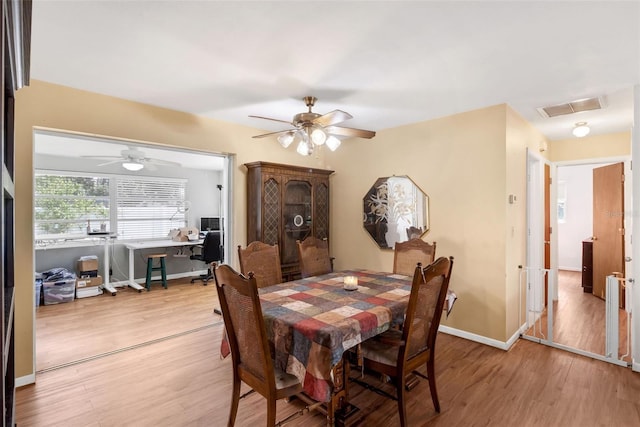 2222 Euclid Cir N, Clearwater, FL 33764 - dining room with light wood finished floors, an office area, a ceiling fan, and baseboards
