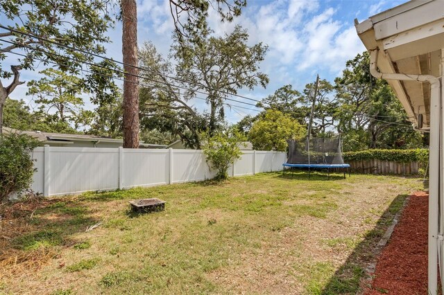 2222 Euclid Cir N, Clearwater, FL 33764 - view of yard featuring a trampoline and an outdoor fire pit