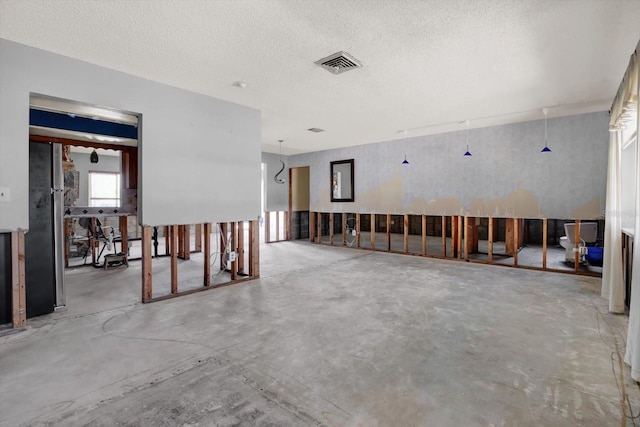 11628 Grove St, Seminole, FL 33772 - empty room with concrete floors and a textured ceiling