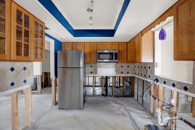 11628 Grove St, Seminole, FL 33772 - kitchen featuring stainless steel appliances, tasteful backsplash, brown cabinetry, and glass insert cabinets